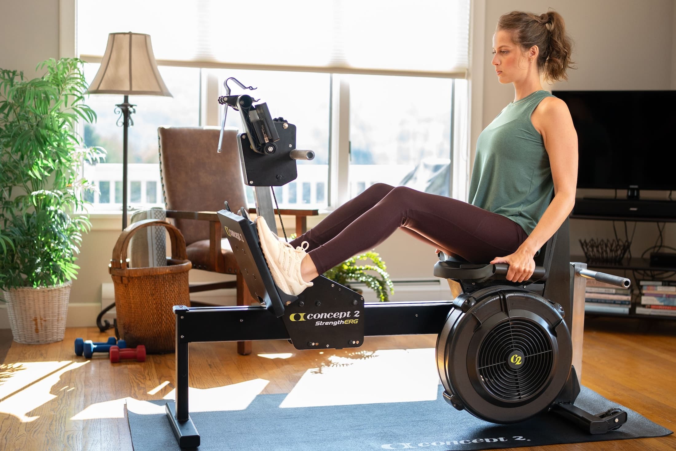 Woman doing a leg press on the Concept2 StrengthErg