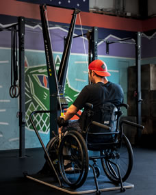 SkiErg and floor stand with wheelchair user